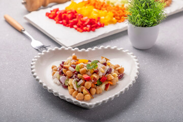 Overnight soaked legume salad of chickpea-kidney beans and other raw veggies mixed with herbs and mild spices