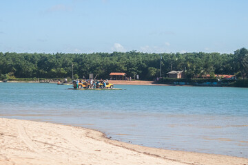 BRAZIL, NATAL - AGO 4, 2017: Colored buggy car crossing river in Genipabu