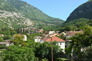 Fototapeta na wymiar Houses located in the valley between the mountains in the town of Kotor. Montenegro