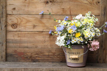 bouquet of summer flowers on the wooden background with copy space