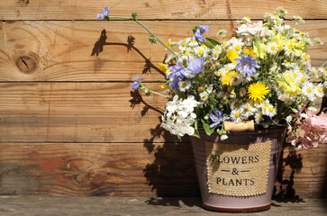 bouquet of summer flowers on the wooden background with copy space