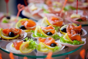 A delicacy of red fish on the festive table. Snacks for guests at the event.