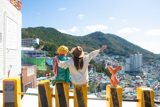 Woman traveller is sightseeing and looking at Gamcheon Culture Village in Busan, South Korea.