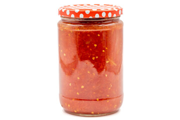 Canned tomato sauce in glass jar isolated on white background