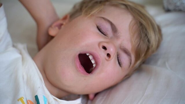 Sick fever child cough and lying in bed. Children cold and flu, coronavirus illness concept. Close up