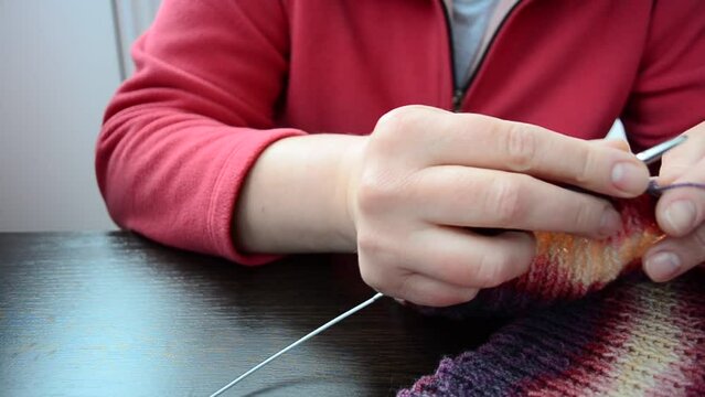 Process of knitting of a scarf. Scarf knitting spokes
