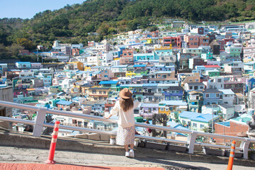 Woman traveller is sightseeing and looking at Gamcheon Culture Village in Busan, South Korea.