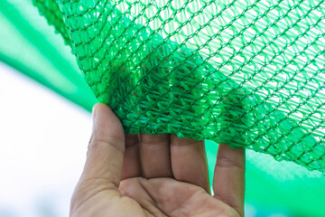 Green shading net pattern texture. Used in gardening, nurseries, agriculture. Texture, weave...