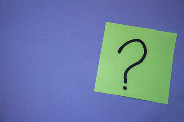 Question mark on purple background with copy space. Curiosity and uncertainty concept.