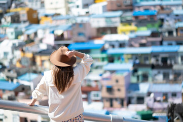 Woman traveller is sightseeing and looking at Gamcheon Culture Village in Busan, South Korea.