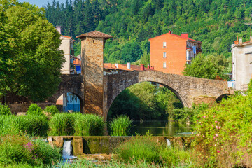 Fototapeta na wymiar Scenic view of a river with an old stone bridge. Puente Viejo, Balmaseda, Spain