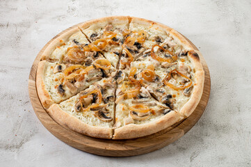 Tasty pizza with mushrooms and onion on the white cincrete background