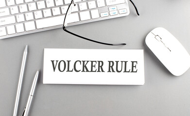 VOLCKER RULE text on paper with keyboard on grey background