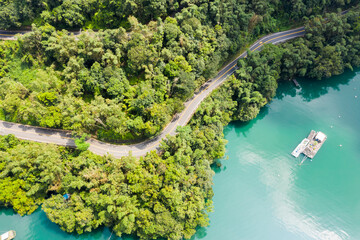 Fototapeta na wymiar road in forest with a boat at Sun Moon Lake