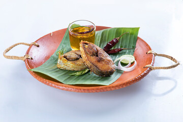 ilish panta Bengali new year festive dish. Boishakh panta ilish with green chilli and onion. Panta bhat is popular among Bengali's in India and Bangladesh. into clay plate seving bowl shanki or sanki