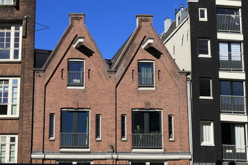 Amsterdam Nieuwezijds Voorburgwal Street Brick House Facades with Spout Gables Close Up, Netherlands