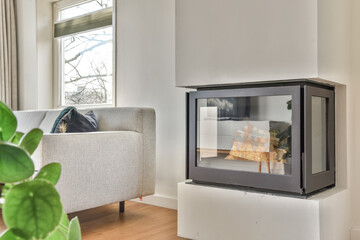 Comfortable sofa and armchair placed near fireplace in cozy spacious living room