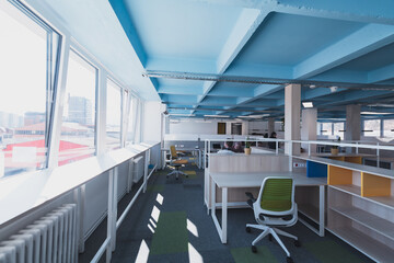 Obraz premium Interior of cozy light boardroom with table, modern stylish chairs and desktop computer, all ready for corporate meeting. Empty spacious office of business company or creative coworking space. 