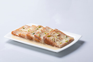 Shahi Tukda tukra dipped in Rabri or double ka meetha diwali sweet made with breadDelicious and creamy Shahi Tukrey (Bread Pudding).Shahi Tukda tukra 