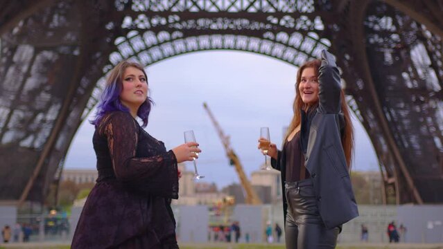 Two teen girls friends siblings couple recording trendy dance moves for posting in internet social media account in Paris. Modern communication and gadgets