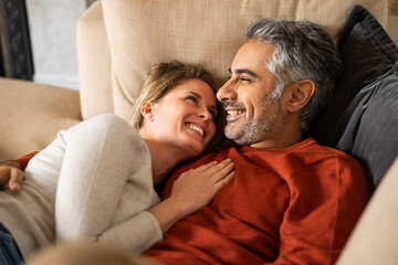 Close up of husband and wife embracing on the couch 
