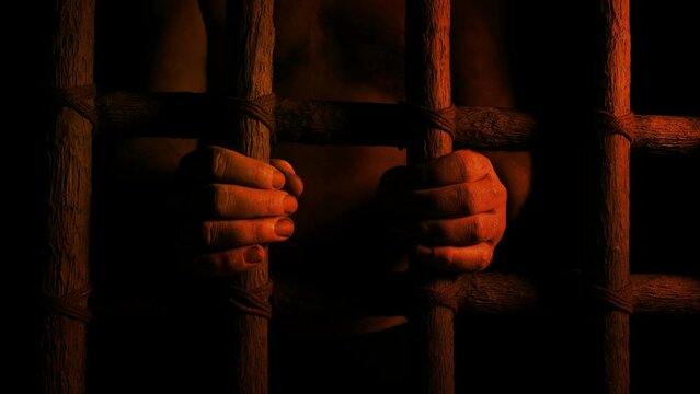 Prisoner Holds Bars In Firelight