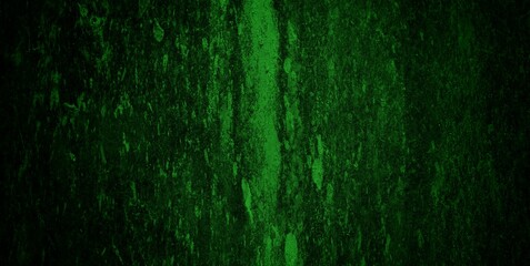 Fototapeta premium A textured green grunge background with dark patches and rough surface