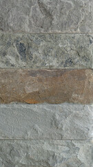 Cladding stone for background and textured. Arranged with gray below and above and brown in the middle.