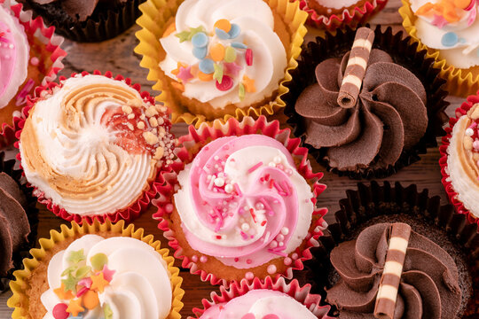 different muffins cupcakes on a wooden background high-quality photos for calendar and cards.