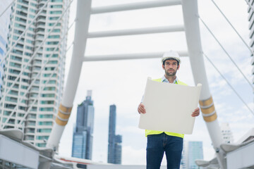 Man engineer standing on construction site. Engineer working on outdoor project