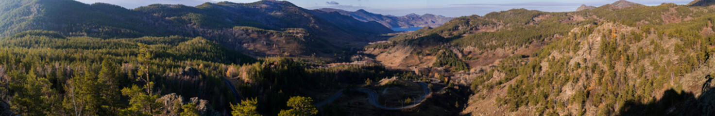 panorama view from the mountain to the gorge with a road and a lake