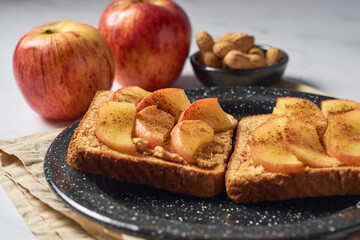 Toasts with peanut butter and apple. Healthy vegetarian breakfast concept.