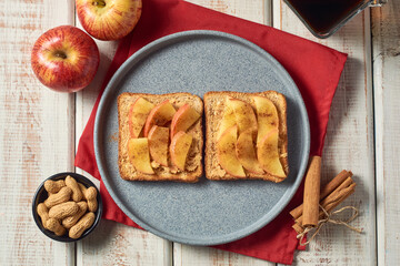 Toasts with peanut butter and apple. Healthy vegetarian breakfast concept.