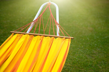 Orange hammock for rest and relaxation in the fresh air.Take a break from work.Details of a hanging bed on the street.