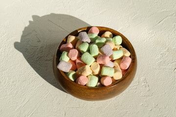 Multicolored marshmallows background. Mini powder cover candies. White background