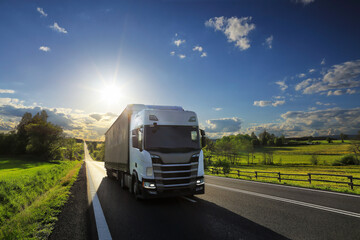 Truck transport on the road at sunset and cargo