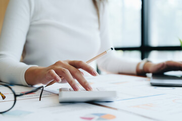 Accountants, Asian auditors are using calculators and computers to review annual tax budgets to submit information to the IRS.