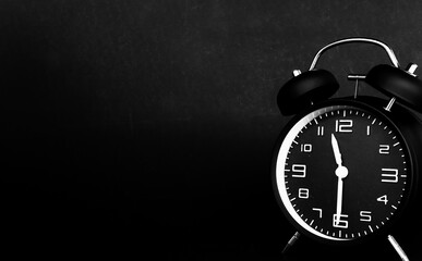 remote image of dark color alarm clock to black background.