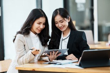 Portrait of businesswoman two people working with computer device in the office room.