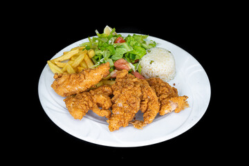 Fried chicken tenders in a white plate on a black background
