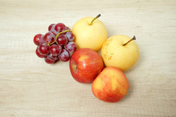 Naklejka na ściany i meble Assorted fresh fruit grapes apples and pears on the table