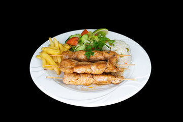 Grilled chicken skewers in a white plate on a black background