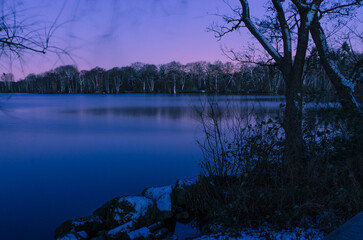 Lake at night in winter at sunrise  