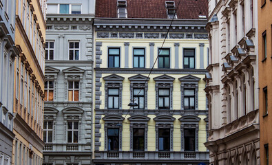 Facade of historical buildings in the old town of Vienna, Austria, Central Europe. Exterior view of heritage houses. Statues, sculptures, figures, ornaments, architectural background.
