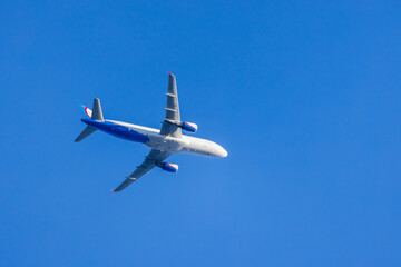 Narrow-body passenger airliner  is in blue sky