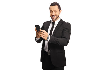 Smiling businessman typing on a phone