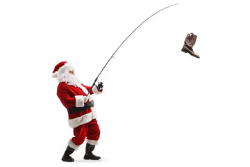 Full length profile shot of santa claus with an old boot on a fishing rod