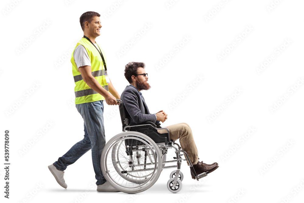 Poster full length profile shot of a community worker pushing a man in a wheelchair