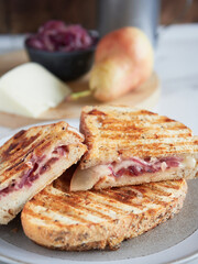 close-up view of a sandwich filling with red onions, pears and cheese