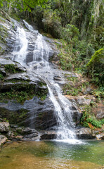 Big waterfall with small lake for bathing in rainforest inside Rio de Janeiro city, Brazil